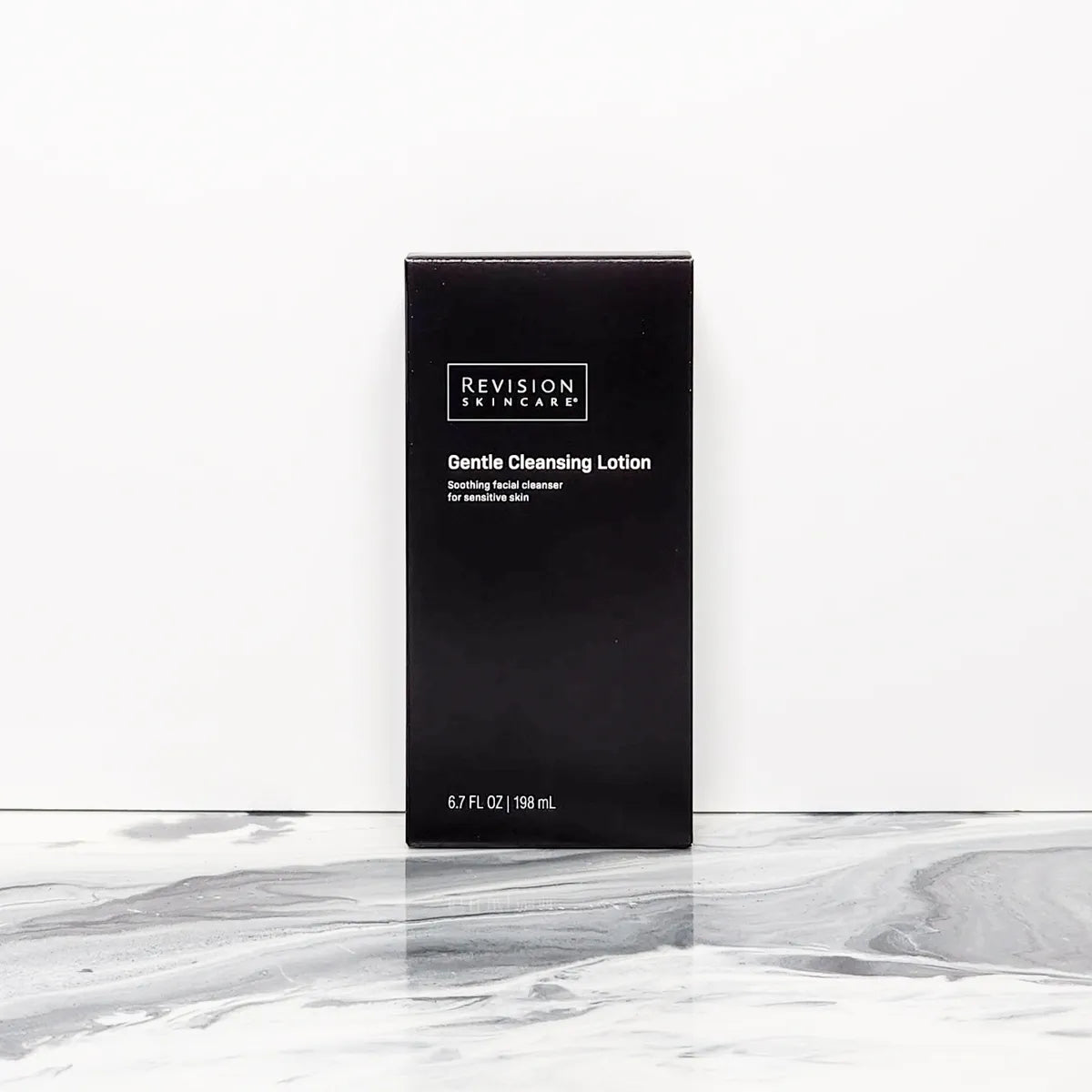 Revision Skincare Gentle Facial Cleansing Lotion packaging on a marble background for gentle hydrating face cleansing.